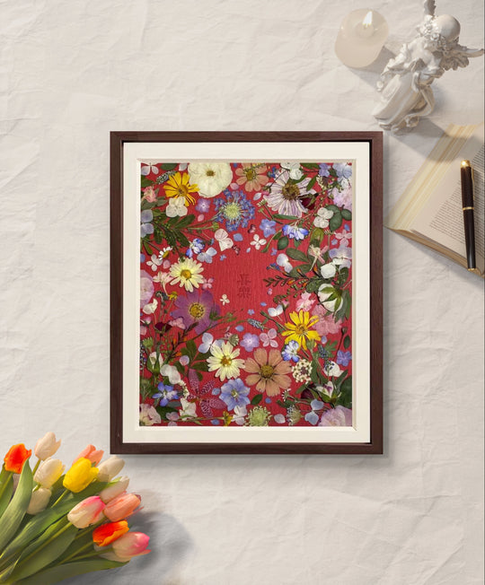 Passionate love theme 11 inches width 12.5 inches height pressed flower frame art lying on the table.