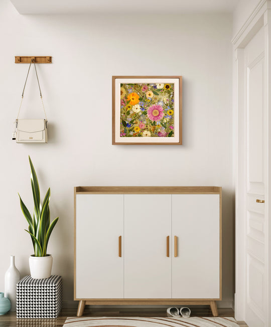 bright theme of pressed flower frame art that used different dried petals filled in every space of canvas hanging above white desk