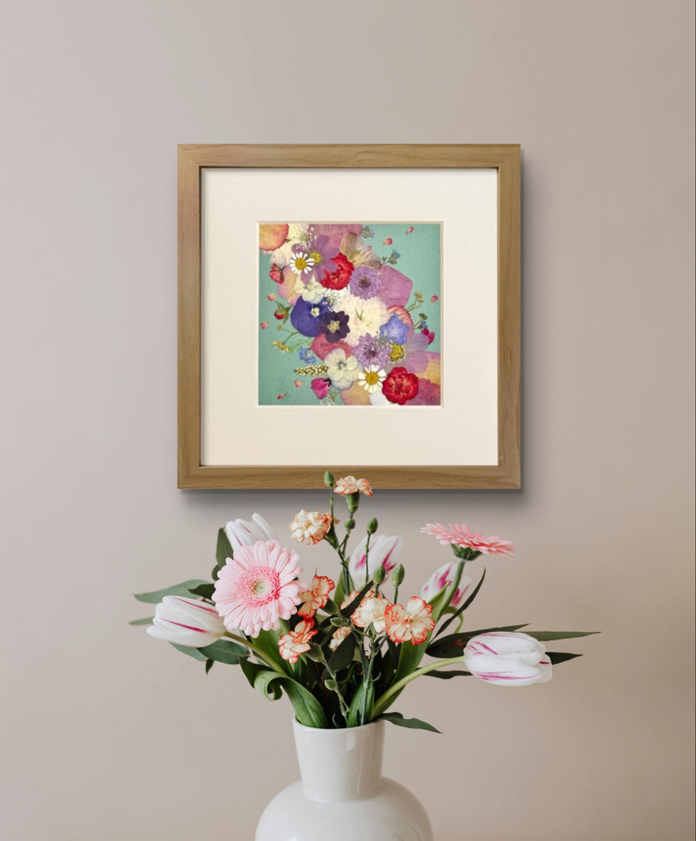 10 inches width 10 inches height pressed flower frame art that is green theme hanging on the wall.