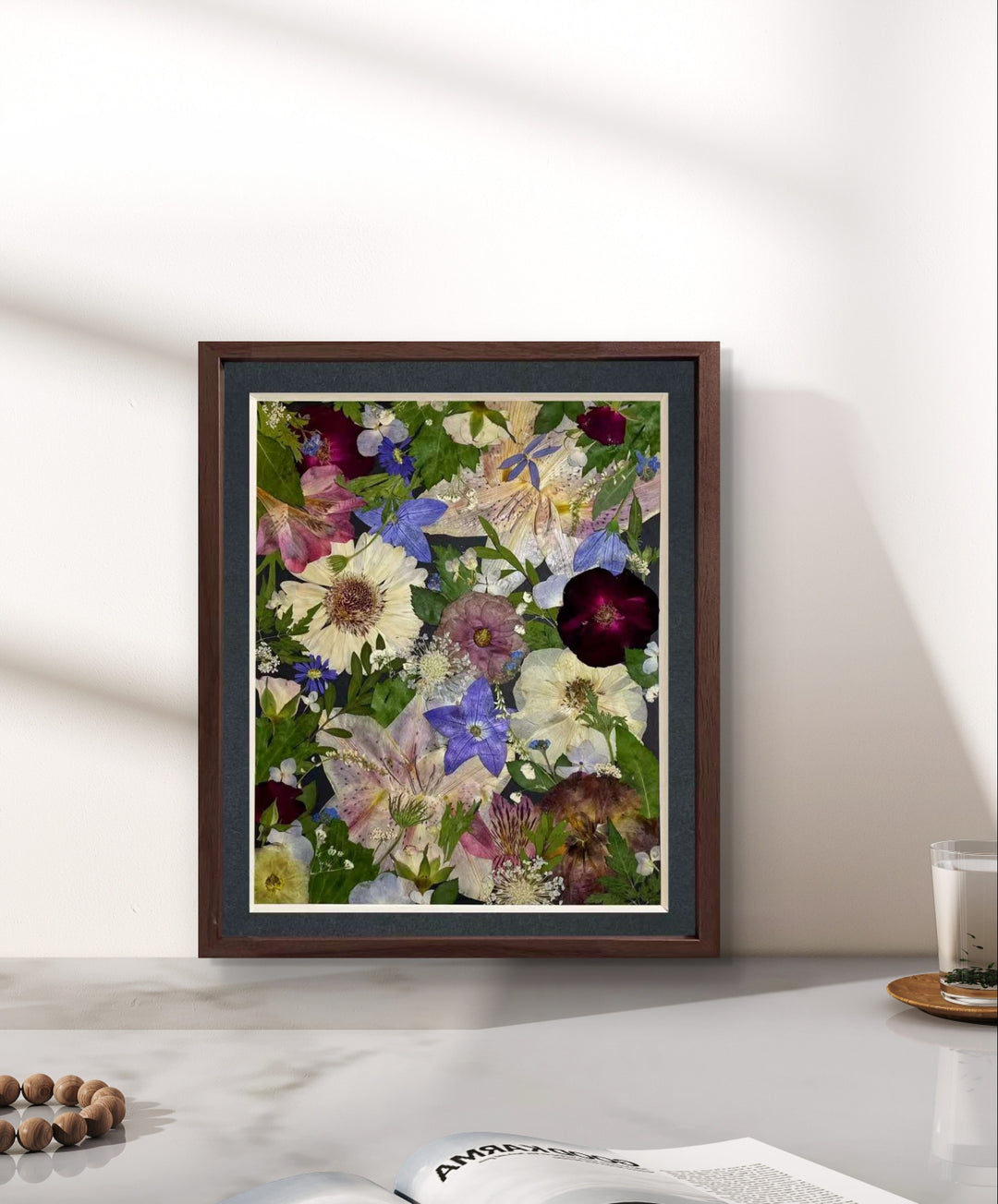 Sparkle stars theme 11 inches width 12.5 inches height pressed flower frame art stands on the table.