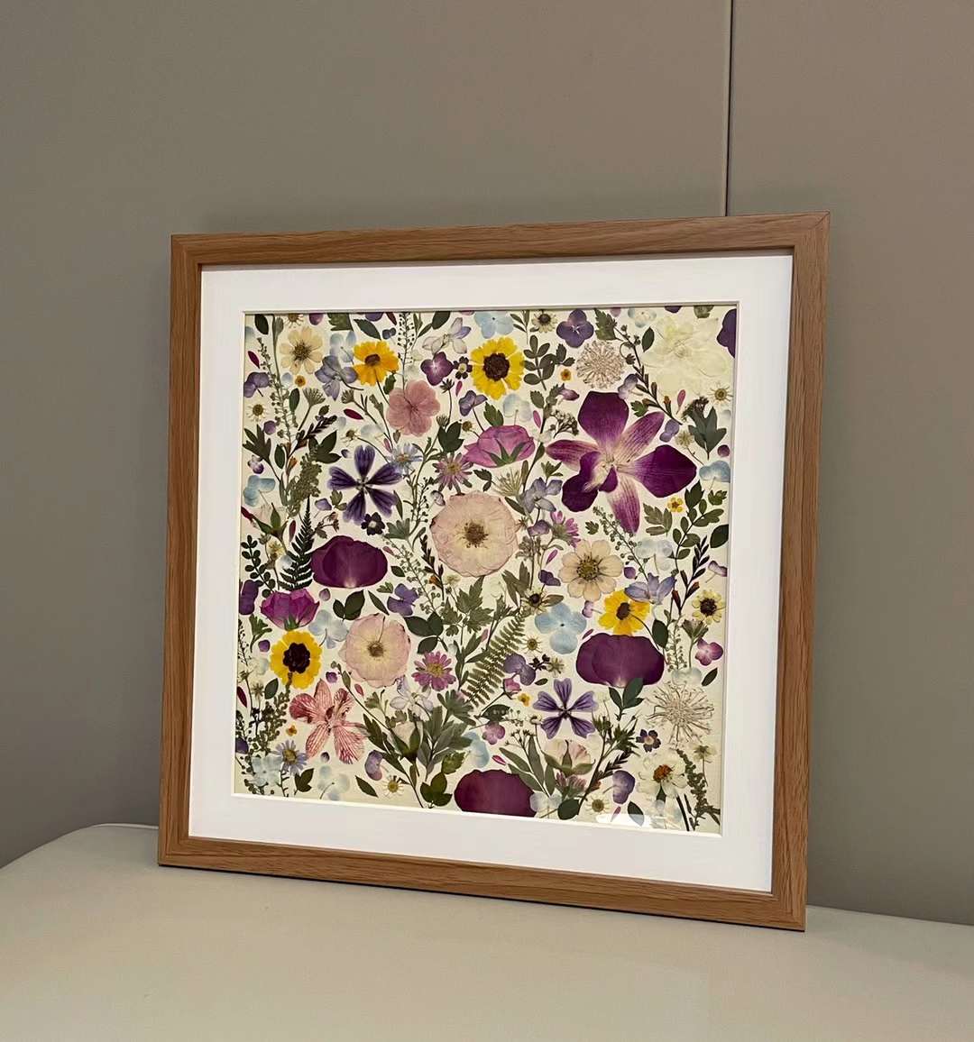 15.7 inch width 15.7 inch height pressed flower frame art that has vibrant and colorful petals formed design.