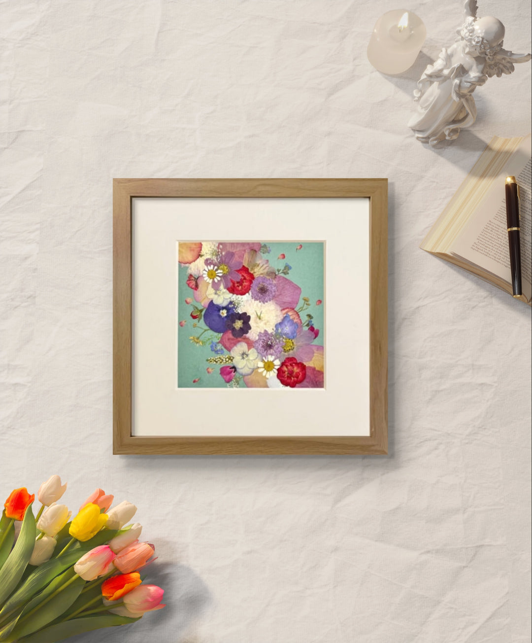 10 inches width 10 inches height pressed flower frame art that is green theme laying on the table.