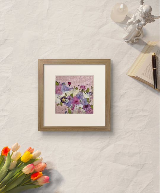10 inches width 10 inches height pressed flower frame art that has pink theme placed on the table