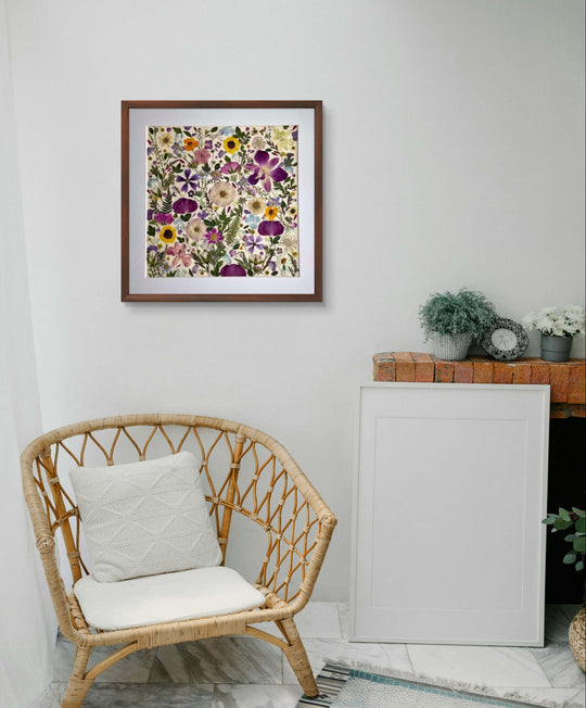 15.7 inch width 15.7 inch height pressed flower frame art that has vibrant and colorful petals formed design hanging on the white wall.